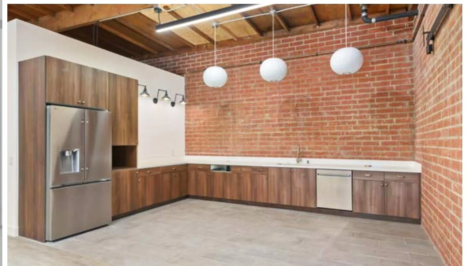 Suite 1524 F kitchen — brick and walnut finishes at 1520 Cloverfield